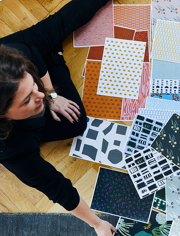 Nina sitting with several fabric samples